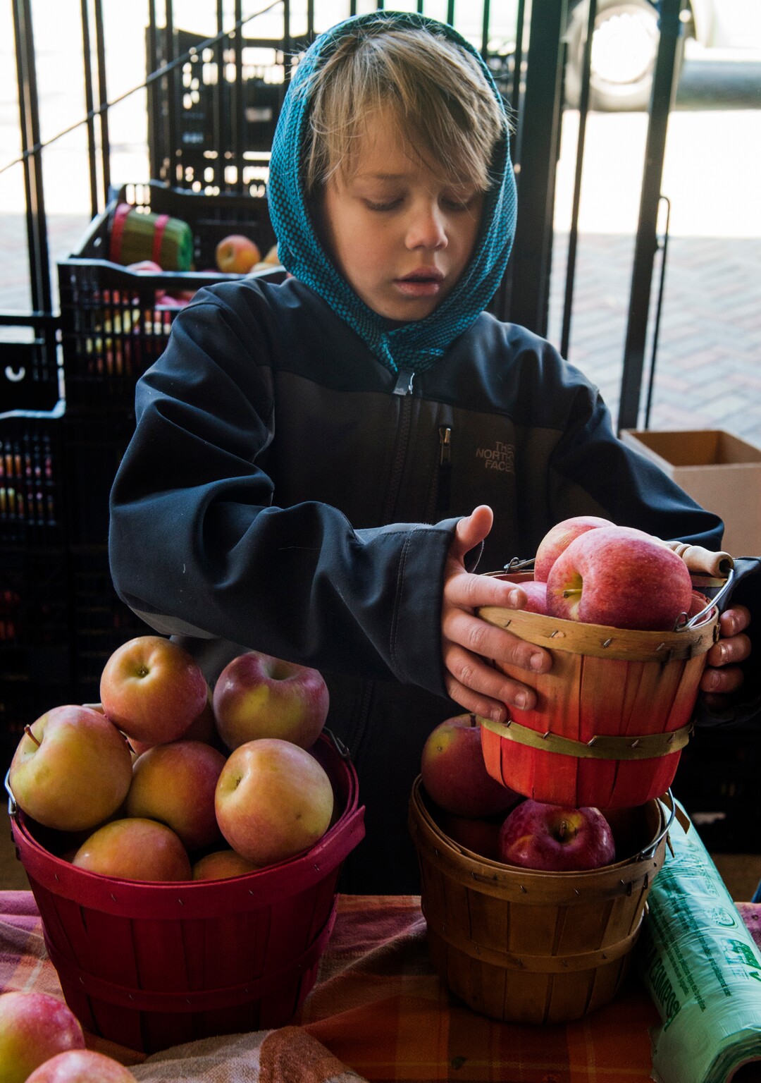 (Rick Egan  |  The Salt Lake Tribune)     Niles Pyne, 9, sells Apples for Pyne Farms, at the Downtown Winter Market which opened today at the Rio Grande Depot, Saturday, Nov. 10, 2018.