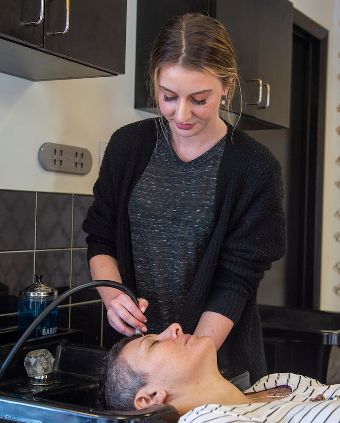 (Rick Egan  |  The Salt Lake Tribune)     Ellen Stephenson rinces Donna May's hair  at Mid City Salon, Saturday, March 21, 2020.