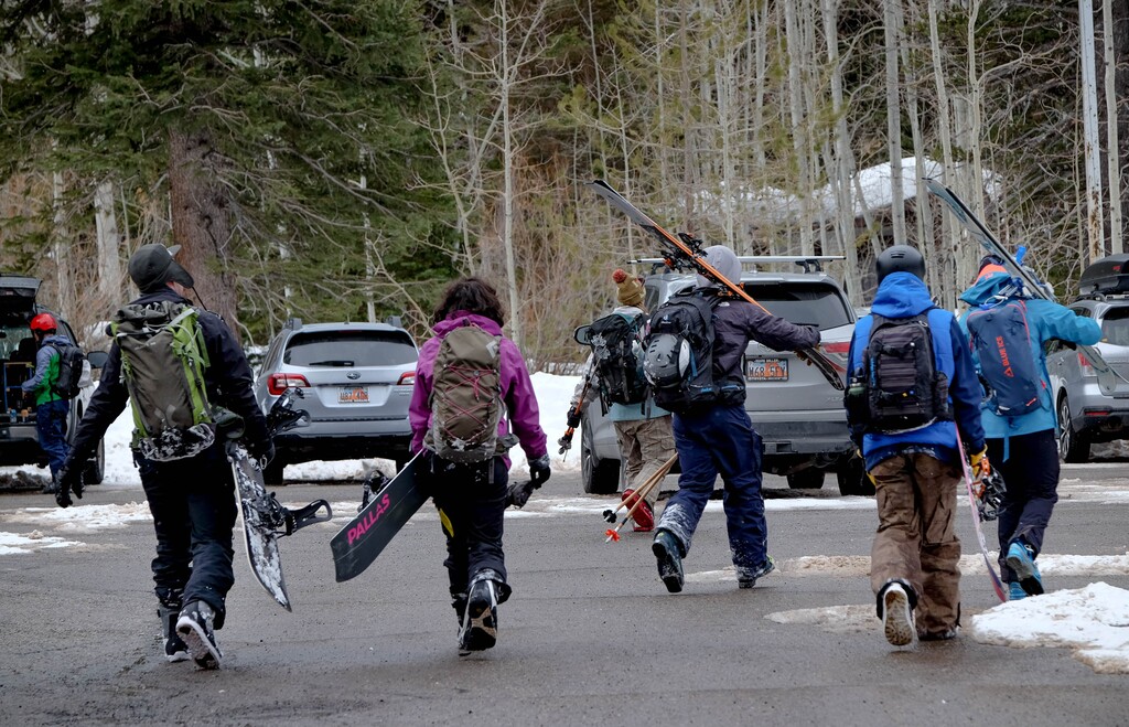 (Francisco Kjolseth  | The Salt Lake Tribune) People return to the Spruces Campground parking lot in Big Cottonwood Canyon after backcountry skiing and snow boarding on Tuesday, Feb. 9, 2021.