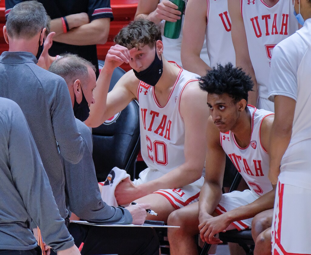 (Leah Hogsten | The Salt Lake Tribune) Utah Utes head coach Larry Krystkowiak focuses on Utah Utes forward Mikael Jantunen (20) and Utah Utes guard Ian Martinez (2) during a timeout as the University of Utah host the Arizona Wildcats, Feb. 4, 2021 at the Jon M. Huntsman Arena.