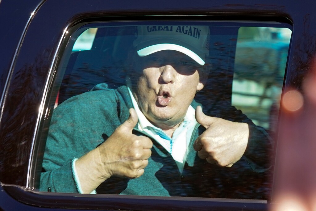 President Donald Trump gives two thumbs up to supporters as he departs after playing golf at the Trump National Golf Club in Sterling Va., Sunday Nov. 8, 2020. (AP Photo/Steve Helber)