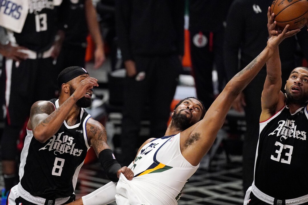 Utah Jazz center Derrick Favors, center, goes after a rebound along with Los Angeles Clippers forward Marcus Morris Sr., left, and forward Nicolas Batum during the second half of Game 3 of a second-round NBA basketball playoff series Saturday, June 12, 2021, in Los Angeles. (AP Photo/Mark J. Terrill)
