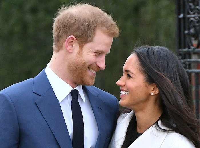 Britain's Prince Harry and Meghan Markle smile as they pose for the media in the grounds of Kensington Palace in London, Monday Nov. 27, 2017. It was announced Monday that Prince Harry, fifth in line for the British throne, will marry American actress Meghan Markle in the spring, confirming months of rumors. (Dominic Lipinski/PA via AP)