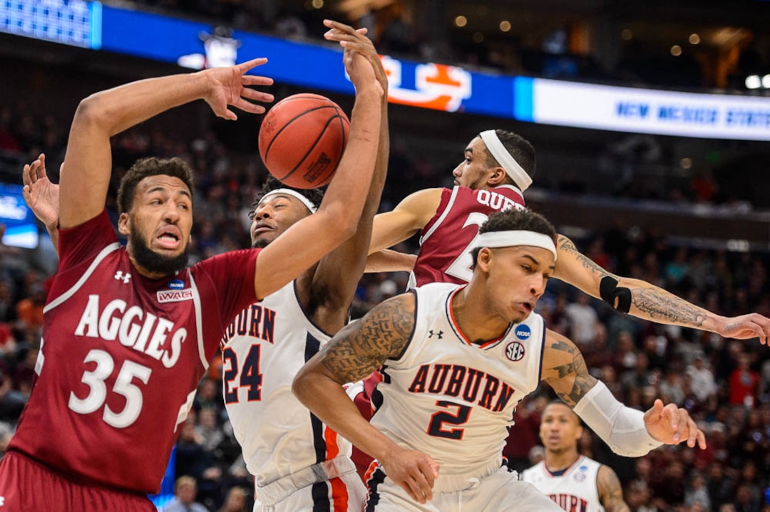 (Trent Nelson | The Salt Lake Tribune)  New Mexico State Aggies forward Johnny McCants (35), Auburn Tigers forward Anfernee McLemore (24), Auburn Tigers guard Bryce Brown (2) and New Mexico State Aggies guard Trevelin Queen (20) as Auburn faces New Mexico State in the 2019 NCAA Tournament in Salt Lake City on Thursday March 21, 2019.