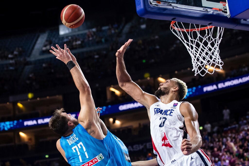 (Marius Becker | dpa via AP) Slovenia's Luka Doncic, left, and France's Rudy Gobert fight for the ball during the Eurobasket group B basketball match between France and Slovenia in Cologne, Germany, Wednesday Sept. 7, 2022.