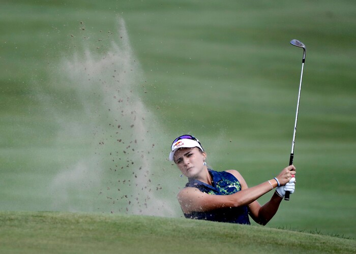 Lexi Thompson hits out of a bunker on the eighth hole during the final round of the Indy Women in Tech Championship golf tournament, Saturday, Sept. 9, 2017, in Indianapolis. (AP Photo/Darron Cummings)
