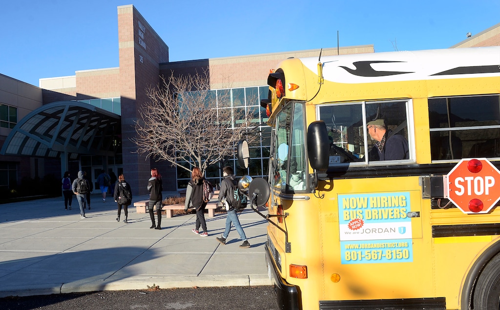 (Al Hartmann | The Salt Lake Tribune) School bus drops off students at Valley High School, Jordan School District's alternative high school Tuesday Nov. 28. The school has added two bus routes over the last two school years – services it has never had in its more than 40 years.
Alternative schools usually never have their own bus routes in Utah. But Sharon Jensen, principal of the high school, rallied for several years to get her students buses to give them better access to an educational environment that can work for them.
The routes pick up between 40 and 45 students between he two buses currently from about five different stops throughout the district.