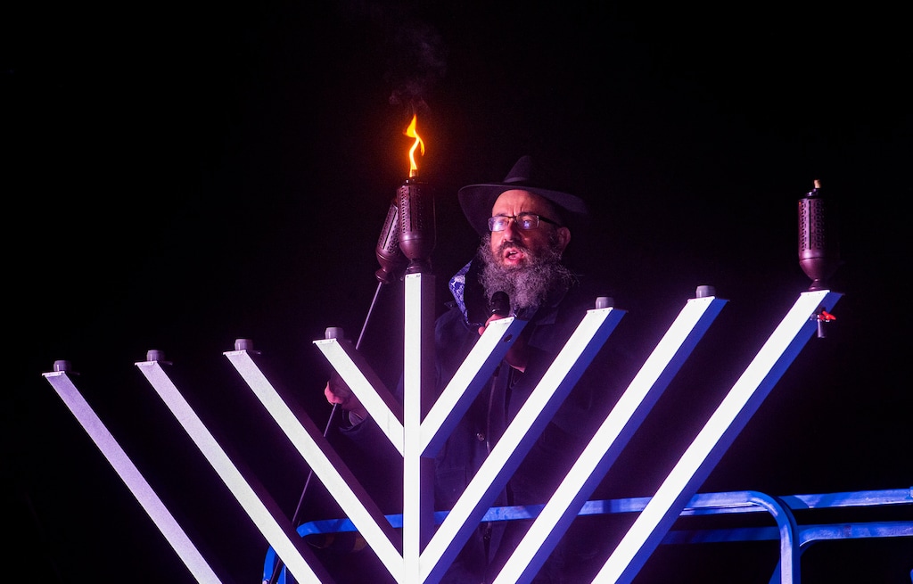 (Rick Egan | The Salt Lake Tribune) Rabbi Benny Zippel lights a 20-foot-tall menorah at the Utah Capitol for the first night of Hanukkah in 2020.