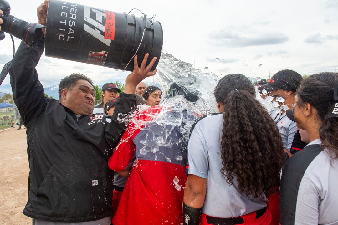 (Rick Egan  |  The Salt Lake Tribune)     West High head coach Keith Lopati gets the drenched with water as the Pantherscelebrates their 5A State Championship win over the Bountiful Braves, in Taylorsville, Thursday May 30, 2019