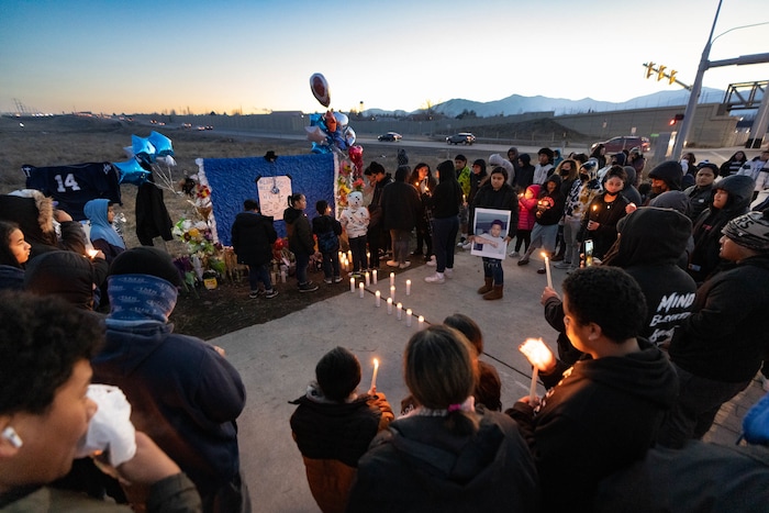 (Francisco Kjolseth | The Salt Lake Tribune) More that a hundred people gather at the candlelight vigil of Hunter High football players Paul Tahi , 15, Tivani Lopati, 14, and Ephraim Asiata, 15, on Friday, Jan 14, 2022, in West Valley City, near Hunter High School along 1400 South at Mountain View Corridor. Paul Tahi and Tivani Lopati were killed in a shooting, while Ephraim Asiata remains in critical condition.