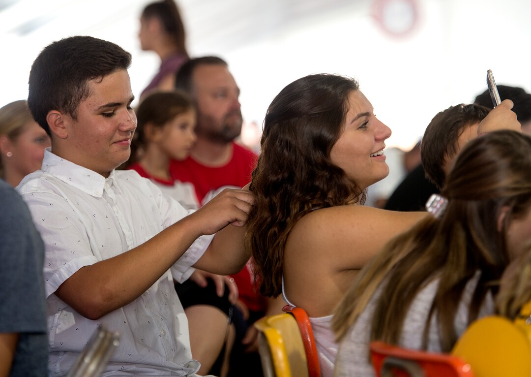 (Leah Hogsten  |  The Salt Lake Tribune) l-r Nektarios Mantas gets his picture taken as he braids the hair of Stavroula Limantzakis prior to their dance performance with the Athenian Dancers at the 42nd Annual Greek Festival on the grounds of the Holy Trinity Cathedral Greek Orthodox Church. The three day festival offers a wide variety of food and pastries, Greek musicians and dance performances.
