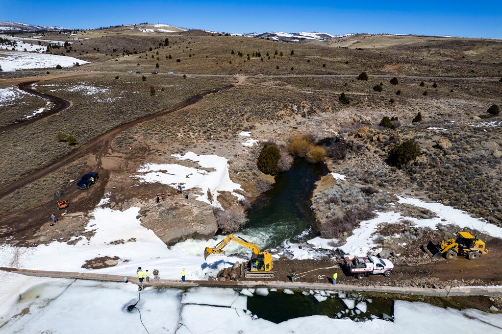 (Rick Egan | The Salt Lake Tribune)  Workers move earth to secure the top of the Panguitch Lake Dam on Thursday, April 11, 2024.