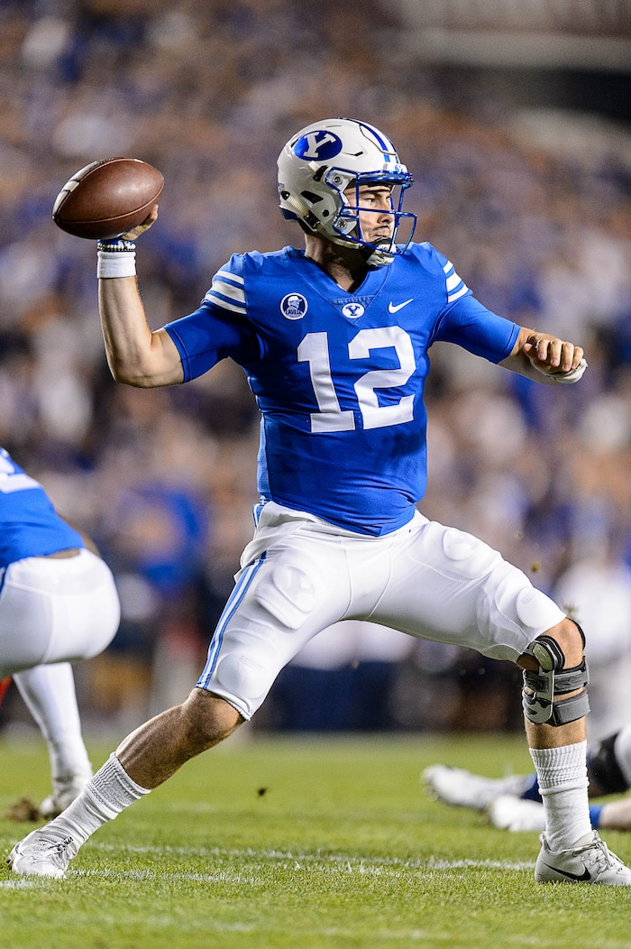 (Trent Nelson | The Salt Lake Tribune)  Brigham Young Cougars quarterback Tanner Mangum (12) throws as BYU hosts Utah, NCAA football in Provo, Saturday September 9, 2017.