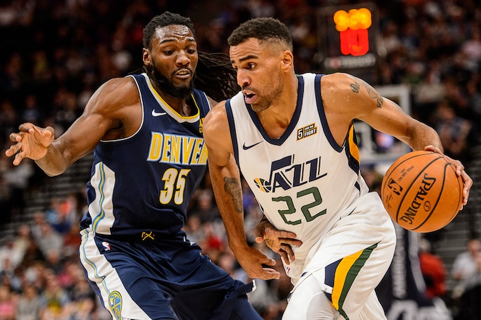(Trent Nelson | The Salt Lake Tribune)  Utah Jazz forward Thabo Sefolosha (22) defended by Denver Nuggets forward Kenneth Faried (35) as the Utah Jazz host the Denver Nuggets, NBA basketball in Salt Lake City, Wednesday October 18, 2017.