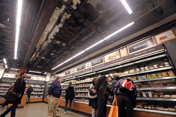 Sensors and cameras, part of a system used to tell what people have purchased, are attached overhead as shoppers walk below, in an Amazon Go store, Monday, Jan. 22, 2018, in Seattle. The artificial intelligence-powered store, which opened to the public Monday, allows shoppers to scan their smartphone with the Amazon Go app at a turnstile, pick out the items they want and leave. The online retail giant can tell what people have purchased and automatically charges their Amazon account. (AP Photo/Elaine Thompson)