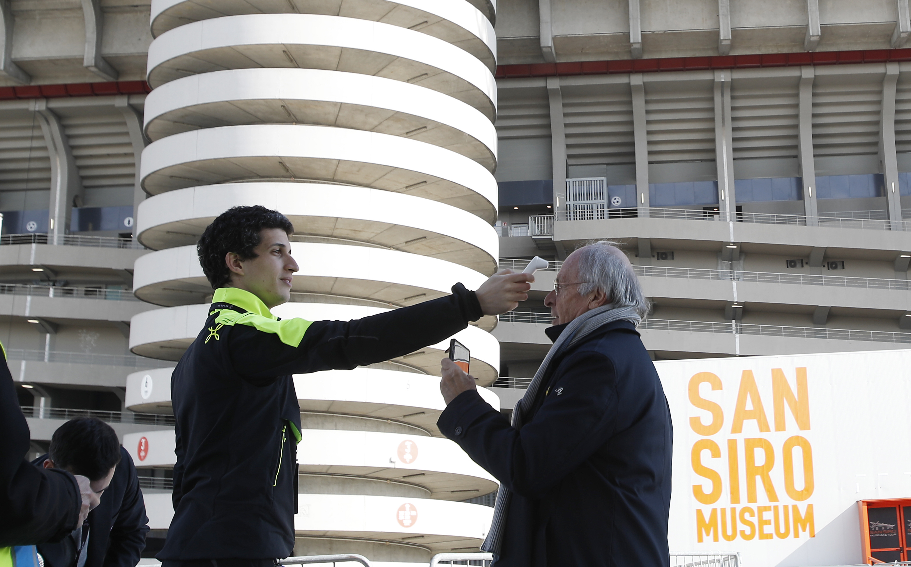 (Antonio Calanni | AP) A journalist has his temperature checked at the entrance of the San Siro stadium during the Serie A soccer match between AC Milan and Genoa, in Milan, Italy, Sunday, March 8, 2020.