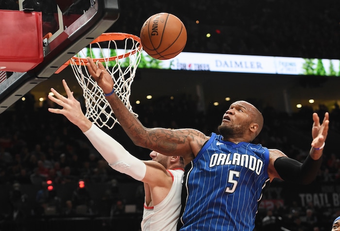 FILE - In this Nov. 15, 2017 file photo, Orlando Magic forward Marreese Speights grabs a rebound next to Portland Trail Blazers center Jusuf Nurkic during the second half of an NBA basketball game in Portland, Ore. The Magic return home after a disappointing four-game road trip in which they have lost their last three games and went 1-3. They are facing a Utah team is playing a back-to-back having lost at Brooklyn, 118-107, on Friday, Nov. 17. (AP Photo/Steve Dykes, File)