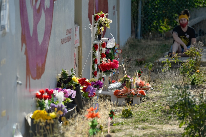 (Francisco Kjolseth  |  The Salt Lake Tribune) People gather for a vigil on the six-year anniversary of Dillon Taylor’s death by the murals of people killed by police near 800 South and 300 West in Salt Lake City on Tuesday, August 11, 2020. Multiple families who’s loved one’s are depicted on the walls joined the vigil as they moved from portrait to portrait to remember them.