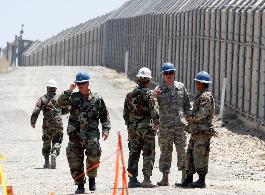 (Denis Poroy | The Associated Press) In this June 21, 2006, file photo, members of the California National Guard work next to the U.S.-Mexico border fence Wednesday, June 21, 2006, near the San Ysidro Port of Entry in San Diego. President Donald Trump said April 3, 2018, he wants to use the military to secure the U.S.-Mexico border until his promised border wall is built. The Department of Homeland Security and White House did not immediately respond to requests for comment. At the Pentagon, officials were struggling to answer questions about the plan, including rudimentary details on whether it would involve National Guard members, as similar programs in the past have done. But officials appeared to be considering a model similar to a 2006 operation in which former President George W. Bush deployed National Guard troops to the southern border in an effort to increase security and surveillance.