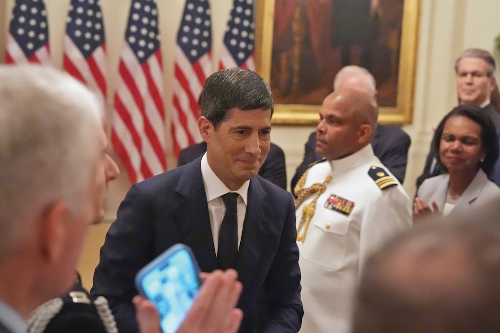 Federal Reserve Chairman Kevin Warsh departs his swearing-in ceremony as Treasury Secretary Scott Bessent, from right, and former Secretary of State Condoleezza Rice look on in the East Room of the White House, Friday, May 22, 2026, in Washington. (AP Photo/Alex Brandon)