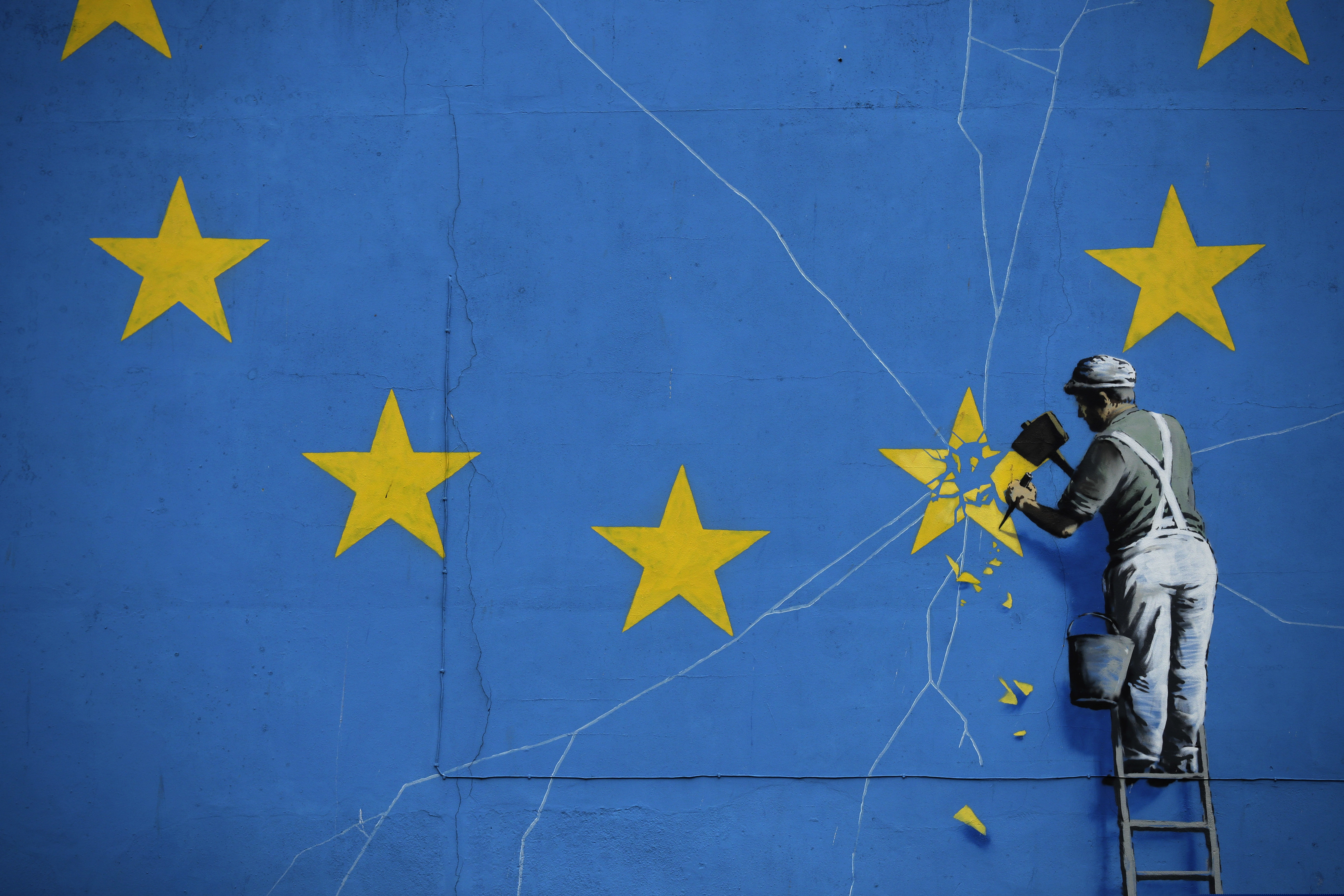 Part of a mural by street artist Banksy showing a star being chiselled from the European flag is seen in Dover, south east England, Monday, Jan. 7, 2019. Britain is testing how its motorway and ferry system would handle a no-deal Brexit by sending a stream of trucks from a regional airport to the port of Dover — even as some legislators try to pressure the government to rule out the scenario. (AP Photo/Matt Dunham)