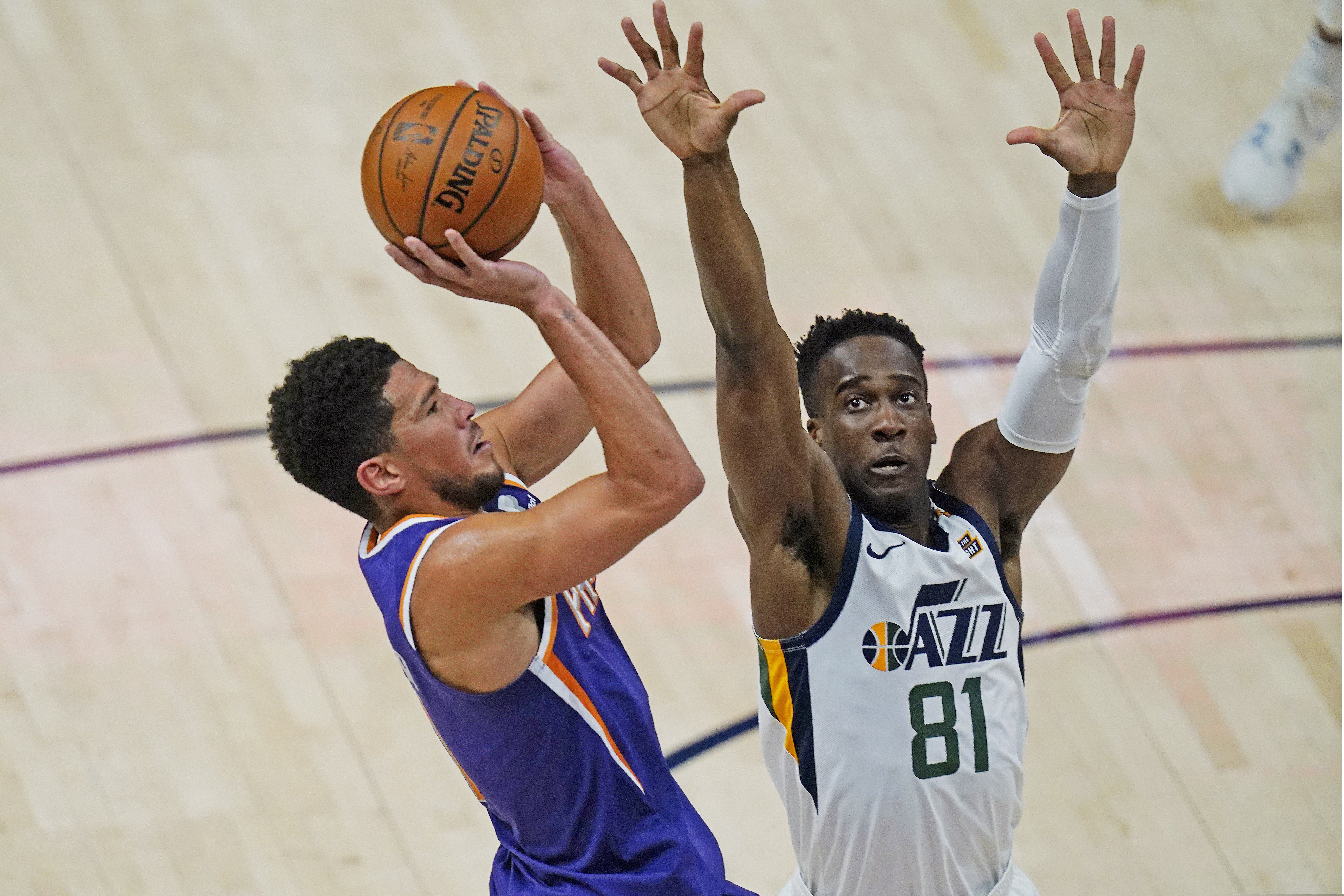 Utah Jazz guard Miye Oni (81) defends against Phoenix Suns guard Devin Booker, left, during the second half of an NBA preseason basketball game, Monday, Dec. 14, 2020, in Salt Lake City. (AP Photo/Rick Bowmer)