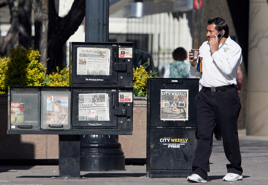 (Rick Egan  | Tribune file photo)  People stream by newspaper boxes on Main Street in Salt Lake City, Thursday, April 25, 2013.