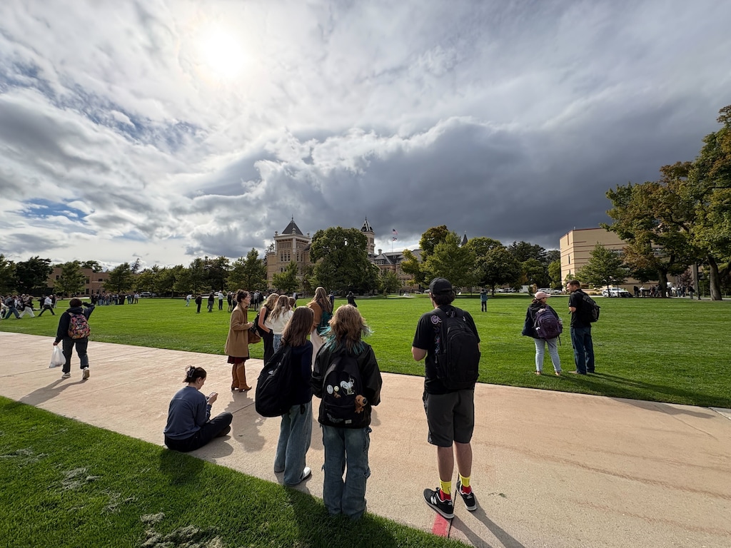(Jeff Parrott) Witnesses look toward the Old Main building on the Logan campus of Utah State University after a small explosion was heard around 3:15 p.m., Sept. 30, 2025. Officials evacuated the building and detonated a suspicious package out of an abundance of caution, a university spokesperson said.