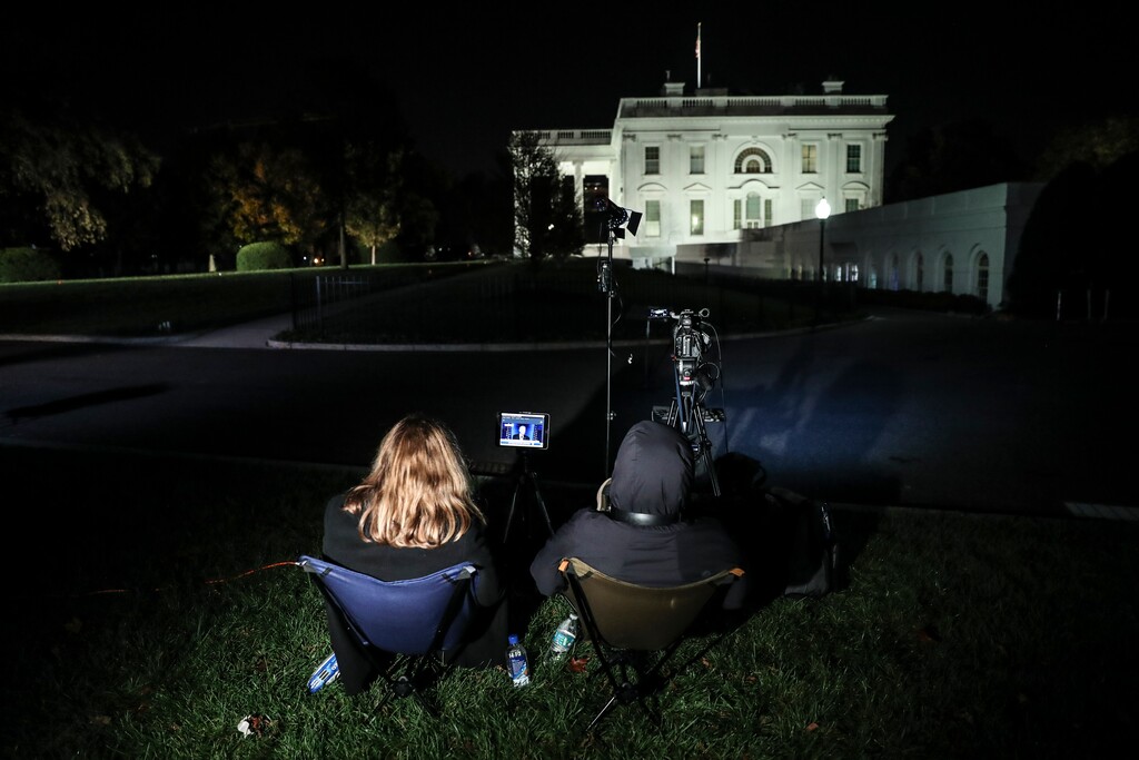 (Oliver Contreras | The New York Times)

Reporters watch Joe Biden, the president-elect, on screen outside the White House in Washington, Nov. 7, 2020.