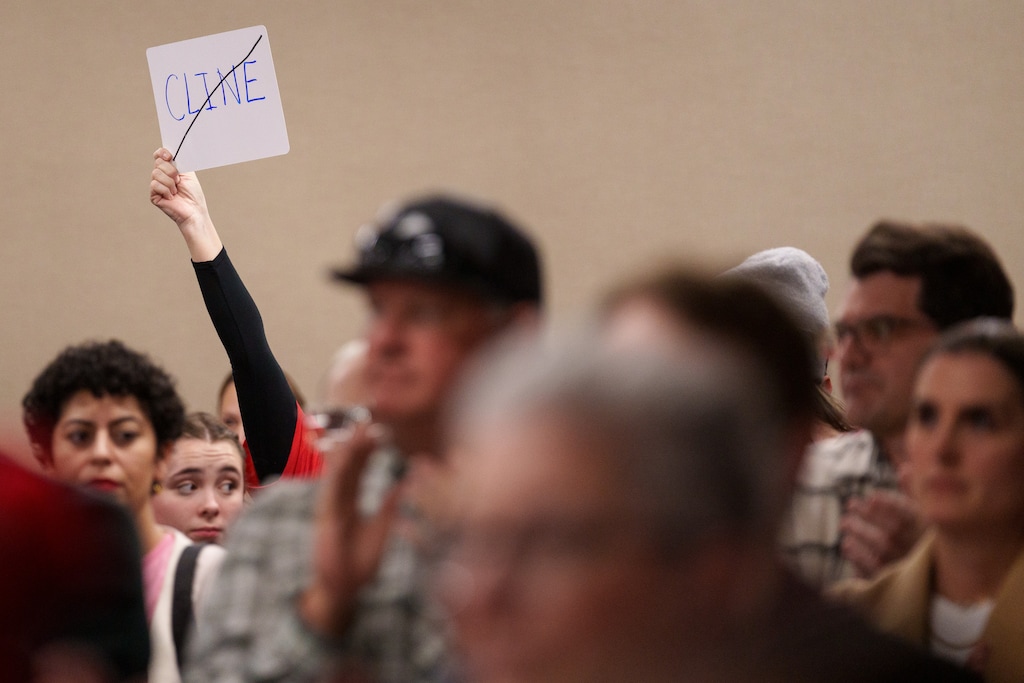 (Trent Nelson | The Salt Lake Tribune) An attendee holds a sign after the Granite School District's board passed a resolution against the actions of Natalie Cline and in support of its student athlete during a meeting in South Salt Lake on Friday, Feb. 9, 2024.