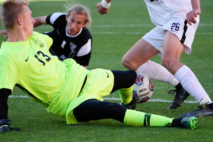 (Francisco Kjolseth | The Salt Lake Tribune) Davis’s goalkeeper Jude Walker (13) makes the block against Herriman during their 6A State Soccer Championship title game at Rio Tinto Stadium, Wednesday, May 25, 2022. Herriman defeated Davis 1-0 with two seconds left on the clock.