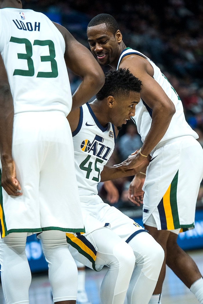 (Chris Detrick  |  The Salt Lake Tribune)  Utah Jazz guard Donovan Mitchell (45) is helped up by Utah Jazz center Ekpe Udoh (33) and Utah Jazz guard Alec Burks (10) during the game at Vivint Smart Home Arena Friday, December 1, 2017.  