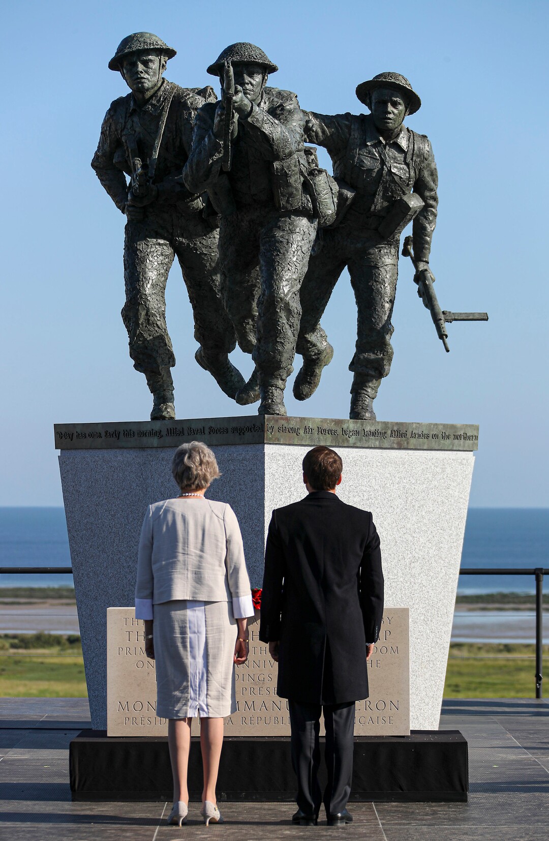 (Ben Shread, MOD via AP) French President Emmanuel Macron and British Prime Minister Theresa May face the new sculpture at the British Normandy Memorial during a Franco-British ceremony to mark the 75th anniversary of D-Day landings at Ver-Sur-Mer, Normandy, France, Thursday, June 6, 2019.