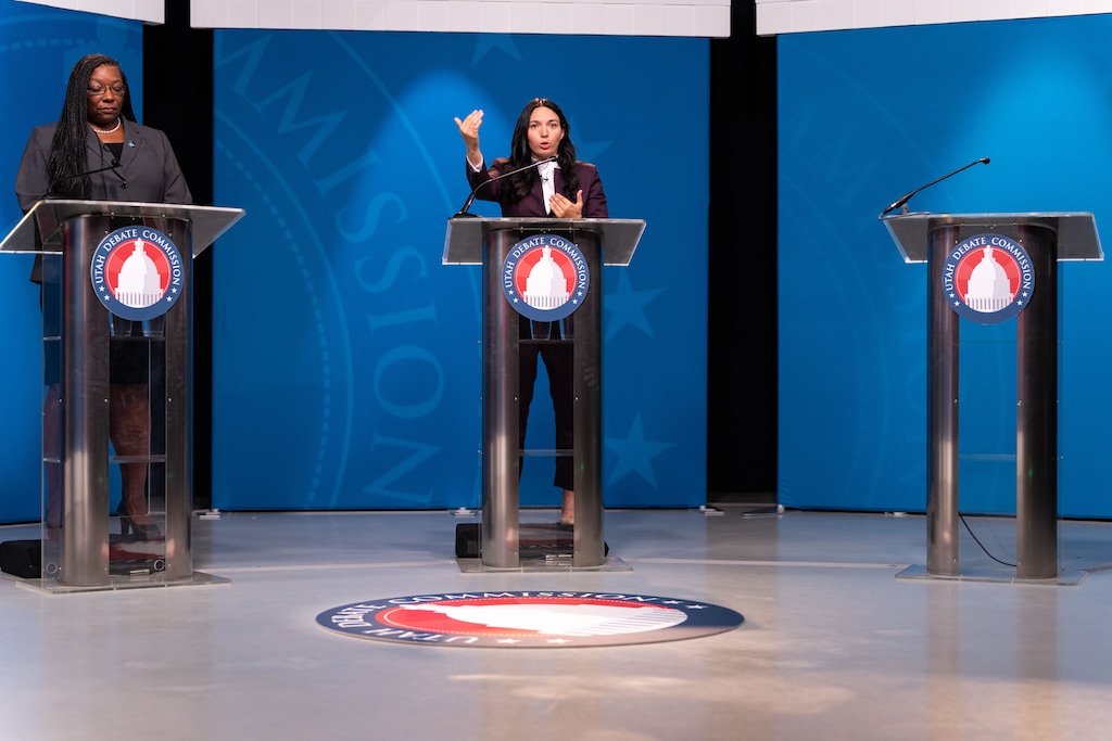 (Xiangyao "Axe" Tang | Pool) Darlene McDonald, left, and January Walker speak in a 4th Congressional District debate at the University of Utah in Salt Lake City, Wednesday, Oct. 12, 2022. Rep. Burgess Owens did not attend and was represented by an empty podium.