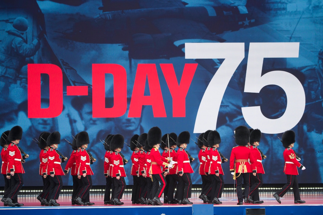 (Alex Brandon | AP) An honor guard marches on stage during a ceremony to mark the 75th Anniversary of D-Day, when the Allied soldiers, sailors and airmen conducted an invasion that helped liberate Europe from Nazi Germany, Wednesday, June 5, 2019, in Portsmouth, England.