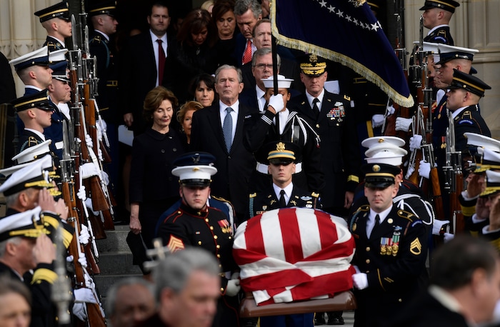 Former President George W. Bush and his wife Laura Bush, center, join their family as they follow the casket of former President George H.W. Bush as it is carried from the State Funeral at the National Cathedral in Washington, Wednesday, Dec. 5, 2018. (AP Photo/Susan Walsh)