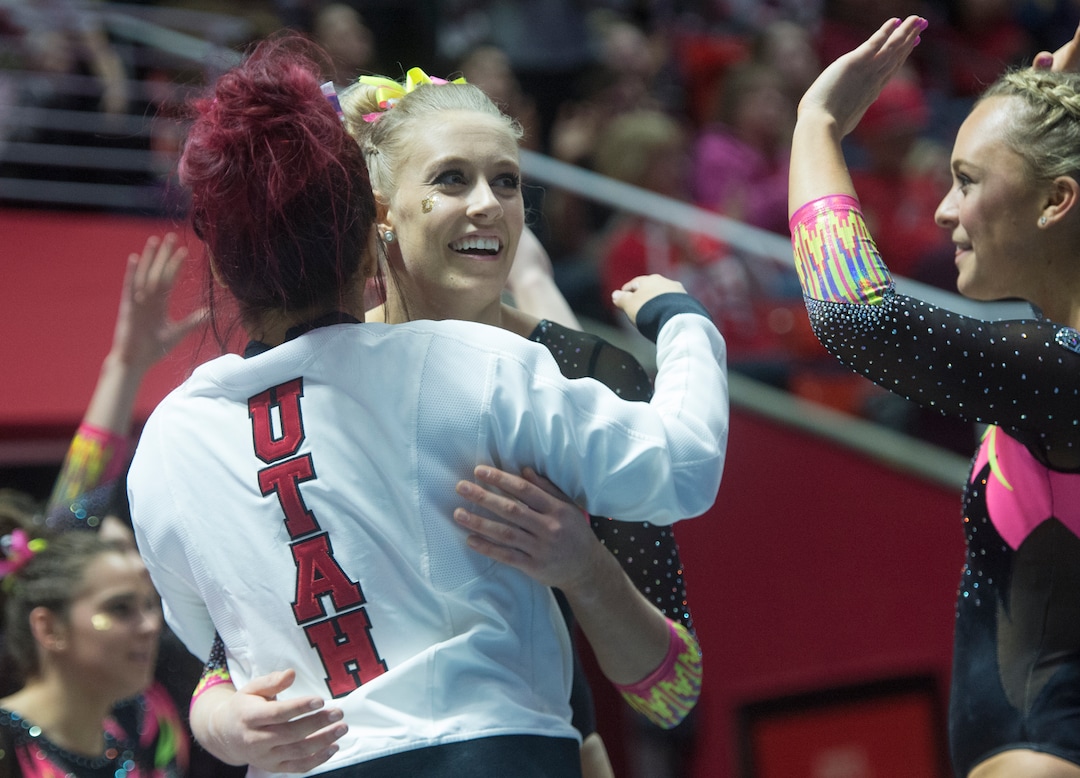 (Rick Egan  |  The Salt Lake Tribune)   Team mates congratulate MaKenna Merrell-Giles after her floor routine for Utah, in Gymnastics action Utah vs. Oregon State at the Jon M. Huntsman Center, Friday, January 19, 2018.