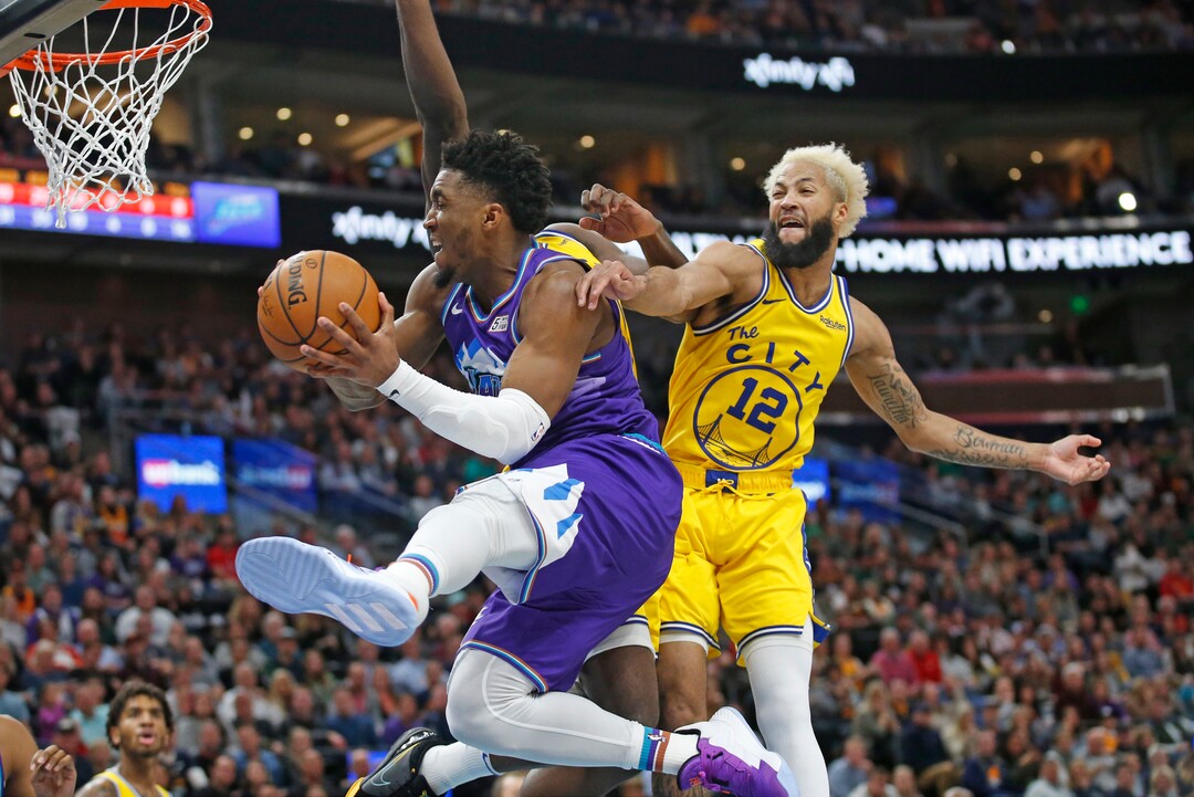 Utah Jazz guard Donovan Mitchell, left, goes to the basket as Golden State Warriors guard Ky Bowman (12) defends during the second half during an NBA basketball game Friday, Nov. 22, 2019, in Salt Lake City. (AP Photo/Rick Bowmer)