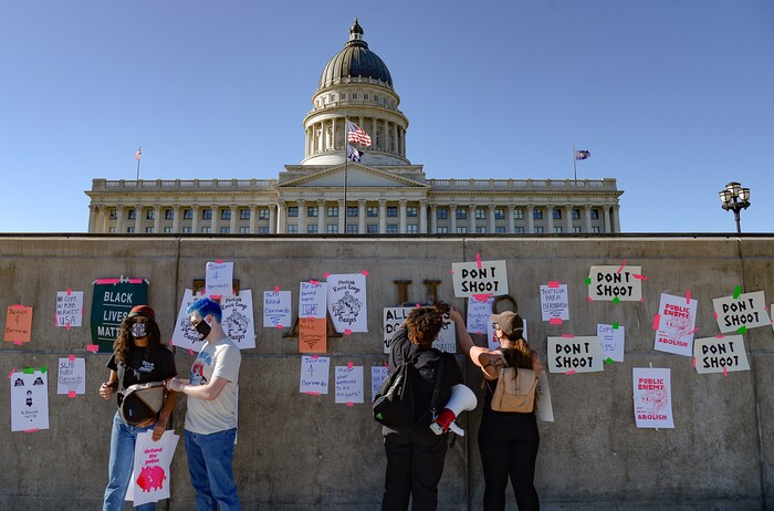 (Francisco Kjolseth  |  The Salt Lake Tribune) Protesters tape signs to the facade outside the Capitol building as part of rally against police brutality on Friday, June 26, 2020. Demonstrators removed the signs before leaving.