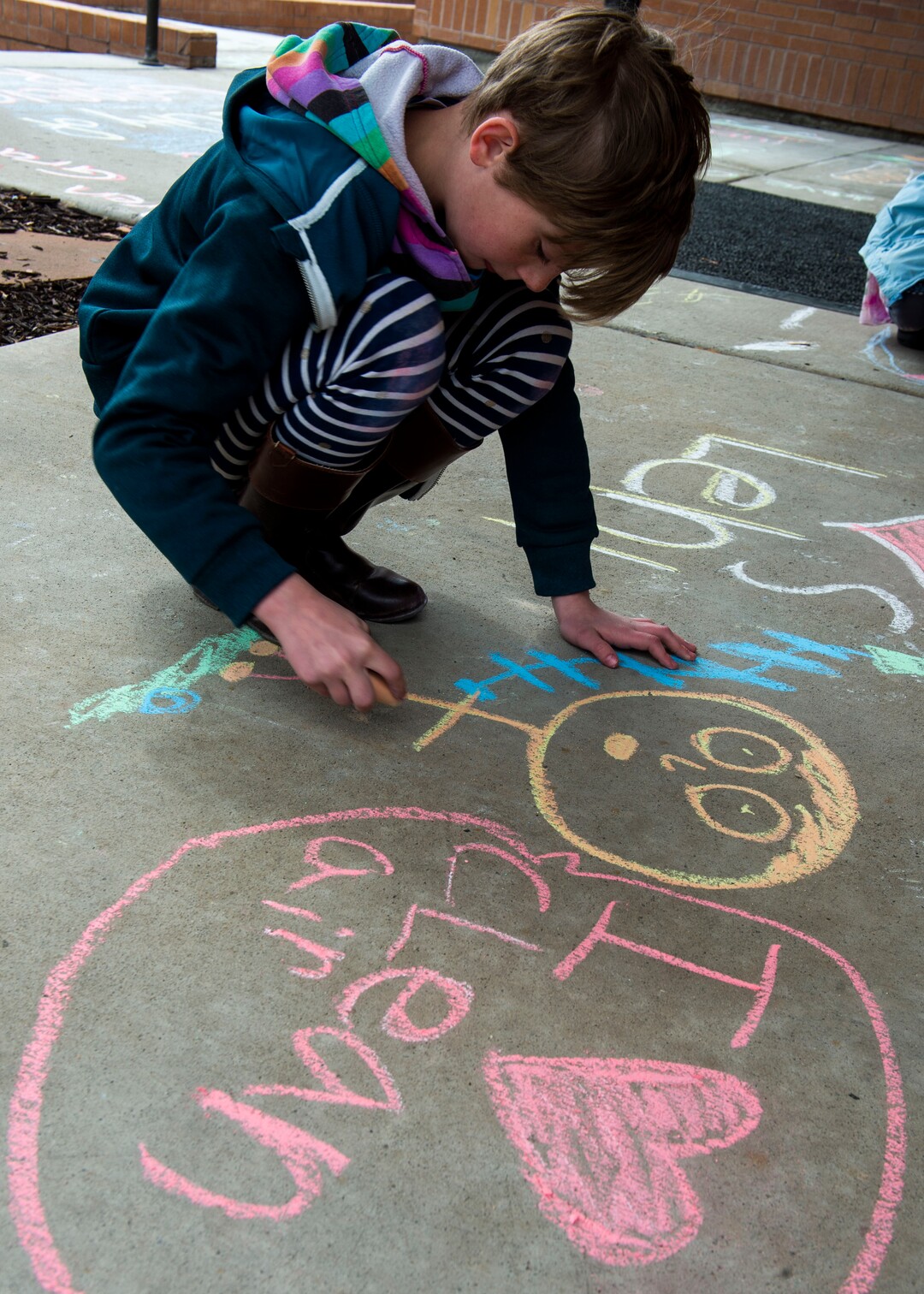 (Rick Egan  |  The Salt Lake Tribune)   Felicity Hoffert 10, draws on the side walk in front of the Lehi City Hall, to protest the expansion of Geneva Rock's mining activities near their neighborhood, Tuesday, April 2, 2019.