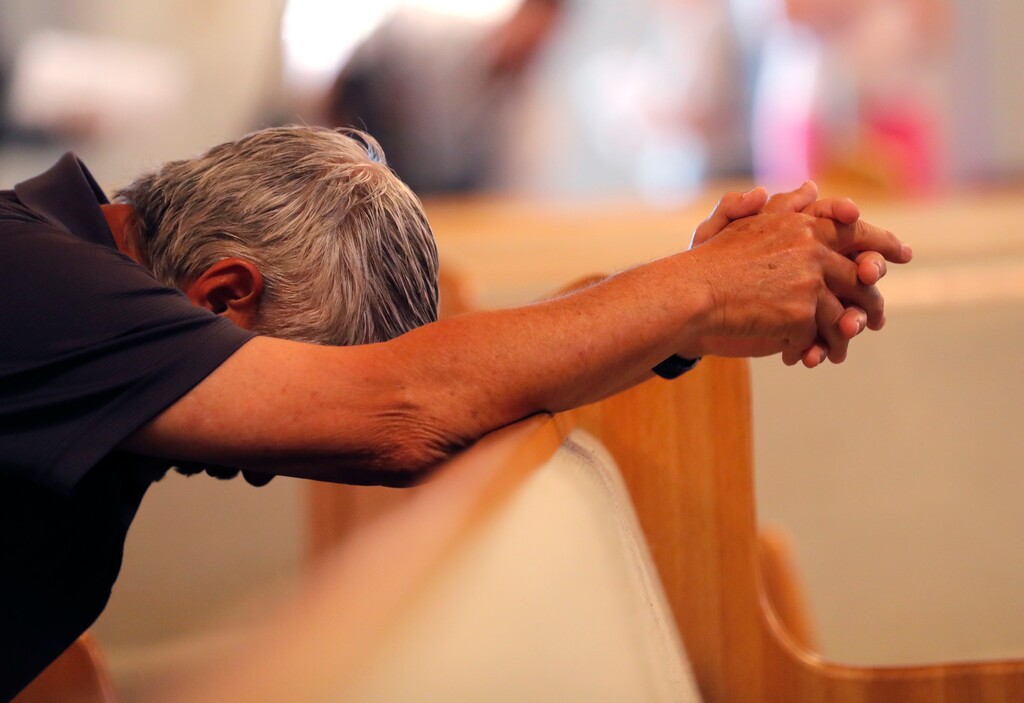 (Gerald Herbert | The Associated Press) A man bows his head in prayer before the start of a service at the First United Methodist Church in Coral Springs, Fla., on Sunday, Feb. 18, 2018. The service was dedicated to the victims of Wednesday's mass shooting at nearby Marjory Stoneman Douglas High School in Parkland. Nikolas Cruz, a former student was charged with 17 counts of murder.