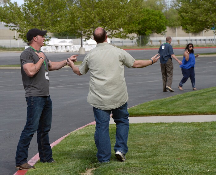 (Al Hartmann | The Salt Lake Tribune)
SLCPD recruit Colby Jeppsen, left, calms a distraught elderly husband, (arms raised) as his partner SLCP recruit Daniel Harman calms a wife suffering from dementia. She jumped out of her husband's car in a parking lot, and ran away, thinking the driver was a kidnapper trying to kill her, in a real life emotional crisis scenario. The recruits had to de-escalate the situation and calm the couple down. The Salt Lake City Police Department hosted a Crisis Intervention Team (CIT) Academy for police officers and police trainees Thursday, May 10, 2018. The academy provides training for officers and recruits to learn about and identify signs of citizens who are experiencing a mental health crisis.
