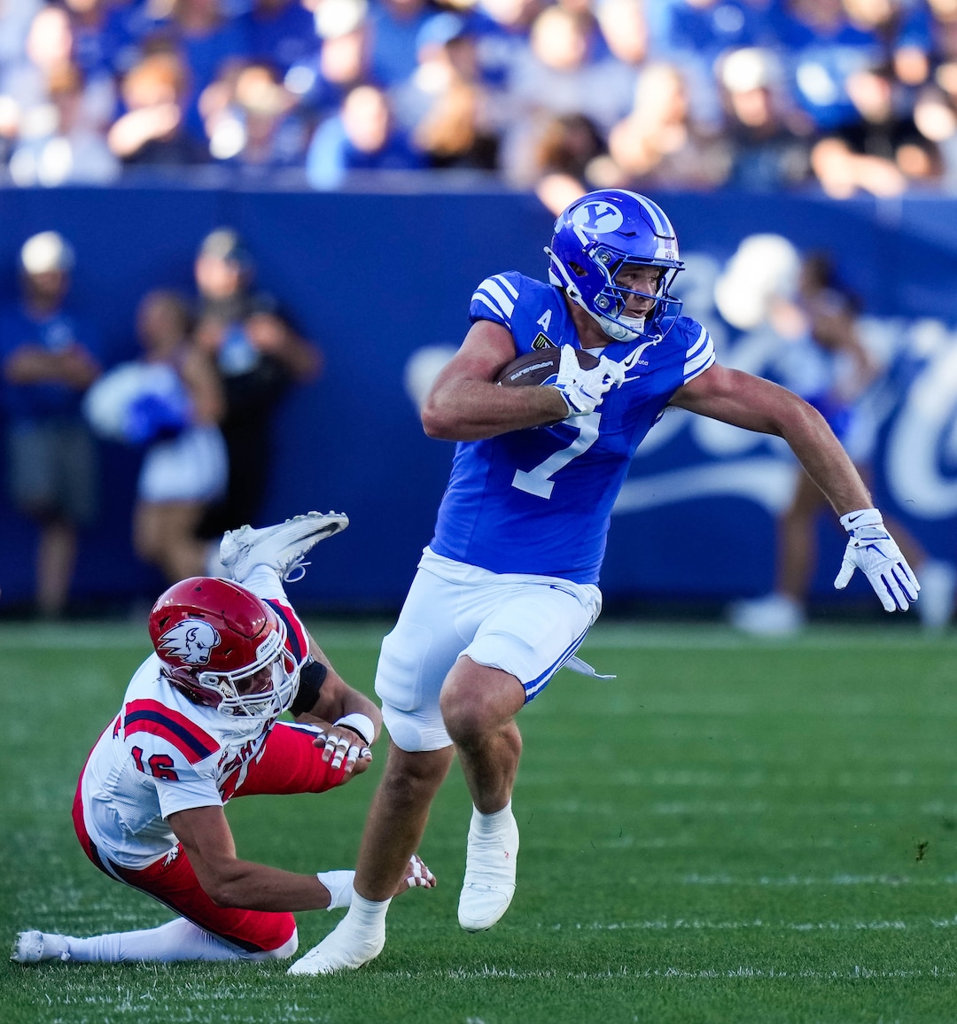 (Francisco Kjolseth | The Salt Lake Tribune) BYU Cougars tight end Walker Lyons (7) pushes past Utah Tech Trailblazers defensive back Jodi Nestan (14) during the first half of an NCAA college football game against Utah Tech, Saturday, Sept. 5, 2026, at LaVell Edwards Stadium in Provo.