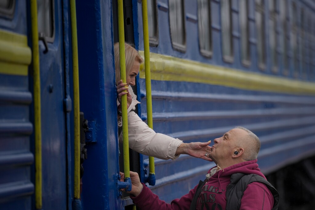 (Vadim Ghirda | AP) A woman bids a man goodbye after boarding a Lviv-bound train, in Kyiv, Ukraine, in March 2022. Tribune guest columnist made a similar trip a decade earlier.