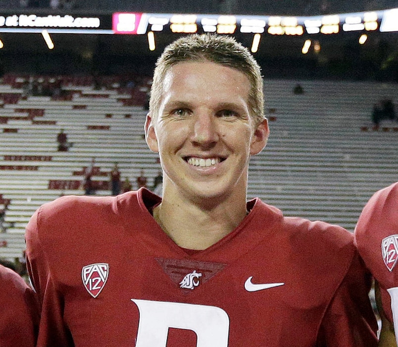 FILE - In this Sept. 9, 2017, file photo, Washington State quarterback Tyler Hilinski poses for a photo after an NCAA college football game against Boise State in Pullman, Wash. The family of the Washington State University football player who died of suicide in January said the 21-year-old quarterback had extensive brain damage that's been linked to concussions from playing the sport. Tyler Hilinski was found dead in his apartment with a gunshot wound and a suicide note on Jan. 16. Mark and Kym Hilinski told NBC's "Today" show on Tuesday, June 26, 2018, that the Mayo Clinic did an autopsy of their son's brain. (AP Photo/Young Kwak, File)