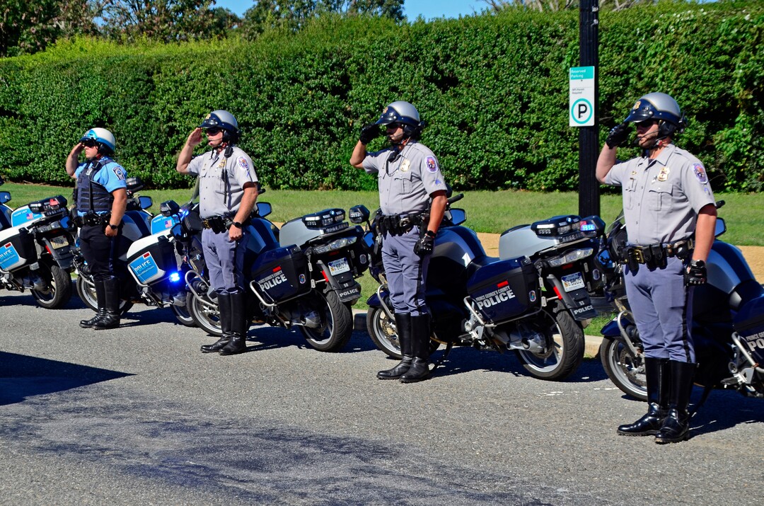 (Danny La | Special to The Tribune) Various Washington D.C. metro area motorcycle police pay their respects as the funeral procession for Staff Sgt. Taylor Hoover proceeds into Arlington National Cemetery on Friday, Sept. 24, 2021. Hoover was killed in action due to a suicide bombing in Kabul, Afghanistan on Aug. 26.