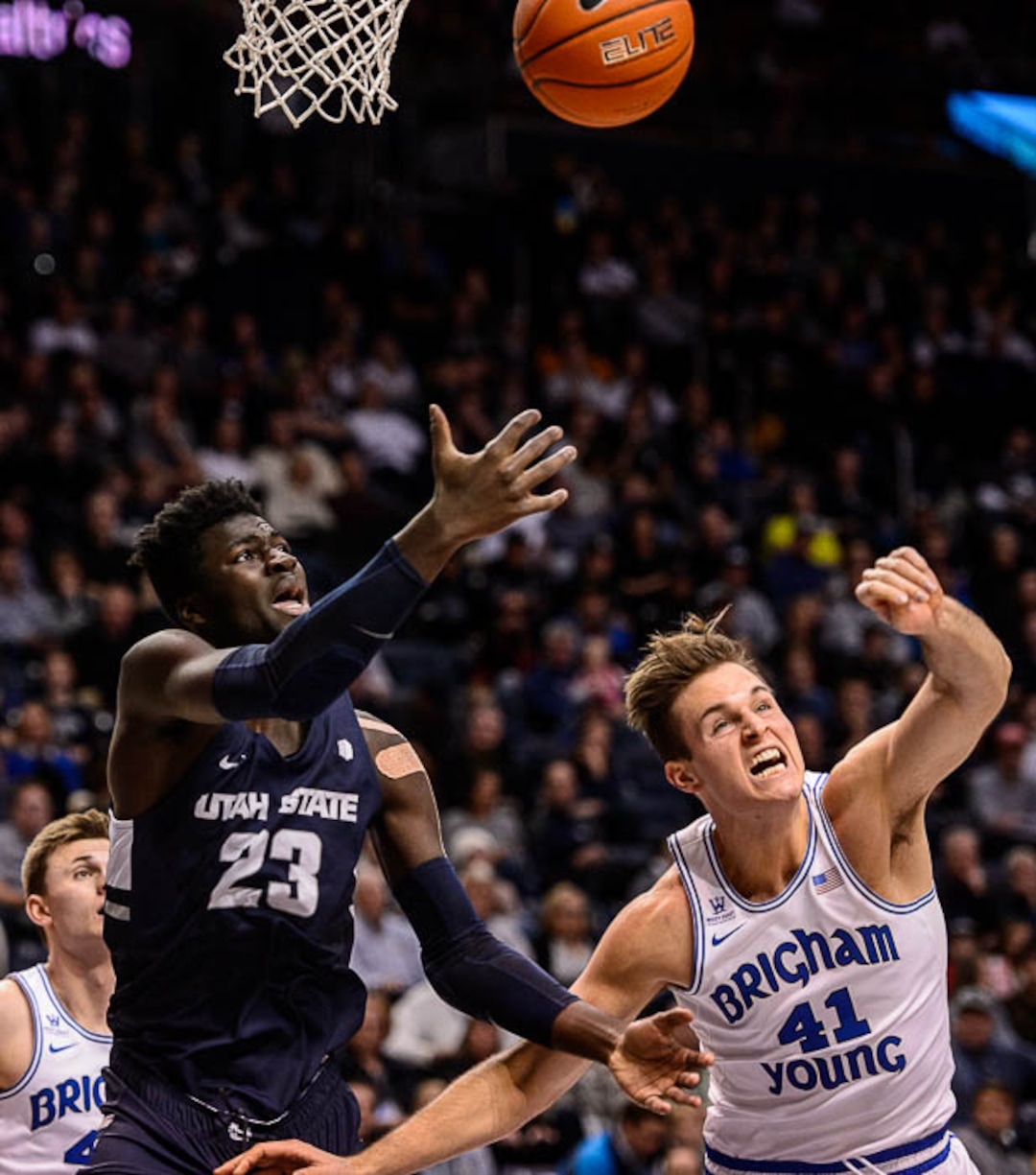(Trent Nelson | The Salt Lake Tribune)  Utah State Aggies center Neemias Queta (23) and Brigham Young Cougars forward Luke Worthington (41) as BYU hosts Utah State, NCAA basketball in Provo on Wednesday Dec. 5, 2018.