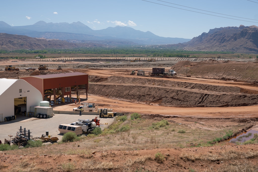 (Trevor Christensen | The Salt Lake Tribune) Construction equipment gathers radioactive mill tailings at the Utah Moab Uranium Mill Tailings Remedial Action (UMTRA) Project on Wednesday, Aug. 14, 2024.
The 480-acre site was once the home of a uranium mill that processed 1,400 tons of uranium ore per day. In 1998, the owner of the mill, Atlas Minerals Corporation, declared bankruptcy. In 2001, the U.S. Department of Energy began the work of cleaning up the 16 million tons of radioactive waste left behind. The site sits just outside Moab on the banks of the Colorado River.