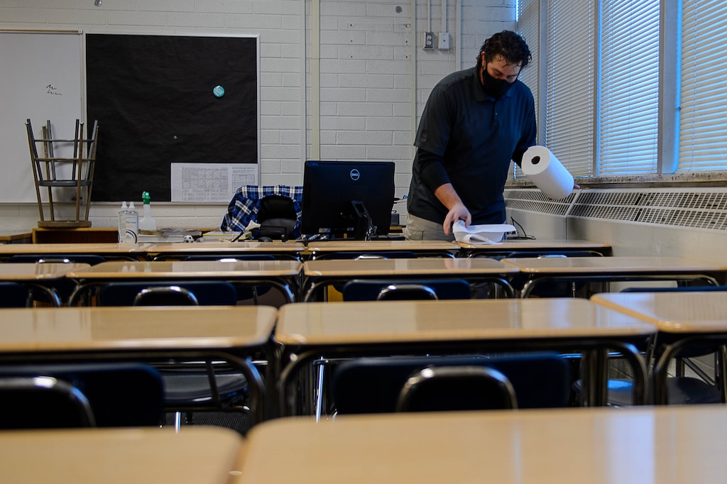 (Trent Nelson  |  Tribune file photo) Science teacher Robert Campos wipes down desks in his classroom as students return to Highland High School in Salt Lake City on Feb. 8, 2021. Utah lawmakers are moving to make it easier for students to receive an excused absence for a mental health day.
