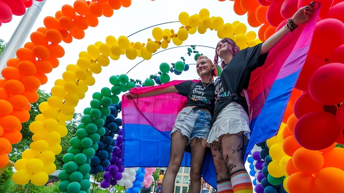 (Leah Hogsten | The Salt Lake Tribune)  Hannah Reed and Hailey Heaps post for photos under the giant balloon rainbow during the Utah Pride Festival at Washington Square, Saturday, June 4, 2022. 
